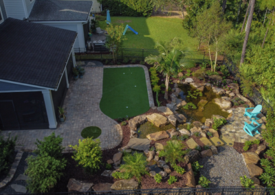 Backyard Oasis water feature with hardscaping and landscaping