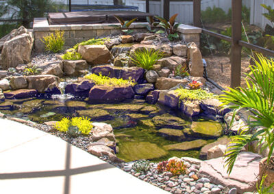 Natural Stone hot tub steps with pond by pool