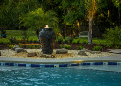 Pool landscape with water feature and rocks 1