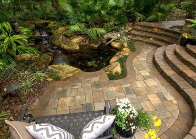 Curvy patio with a pond natural setting
