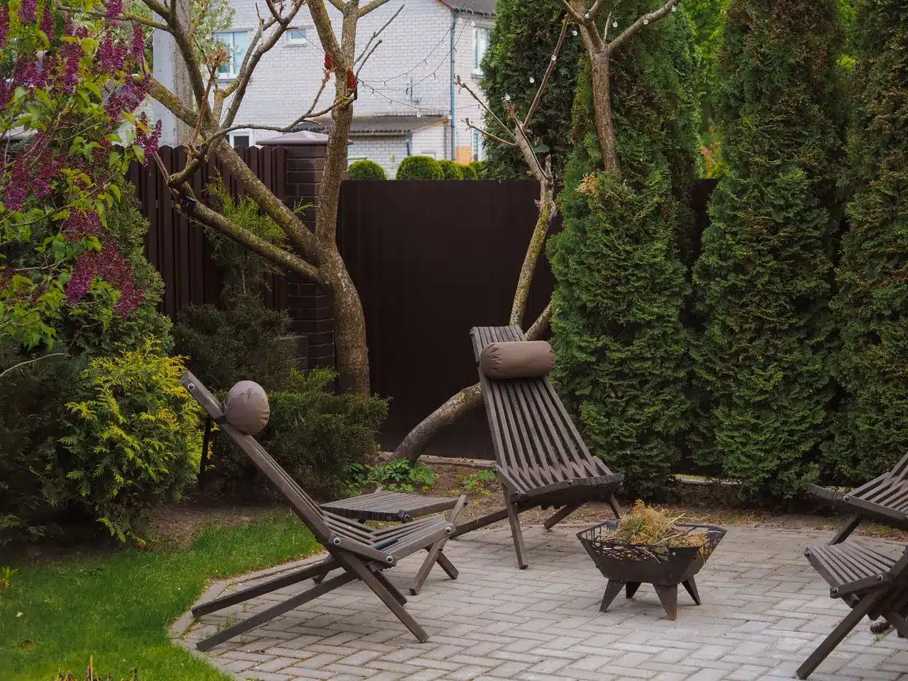 Small backyard divided into functional zones with seating and dining areas